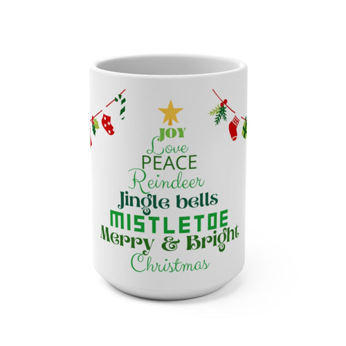 This Christmas tree made up of words: Joy, Love, Peace, Reindeer, Jingle Bells, Mistletoe, Merry & Bright and Christmas written in multiple green tones and different fonts. The tree has a tiny yellow star on top too.  The tree is centered on the mug with Christmas decorations on either side. White background, 15 oz mug